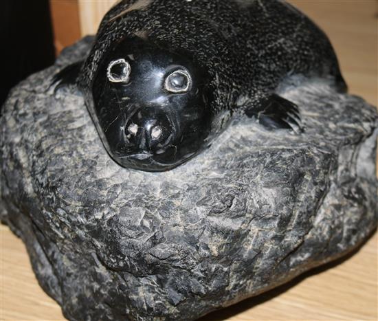 An Inuit carved hardstone model of a seal cub, monogrammed J.G.